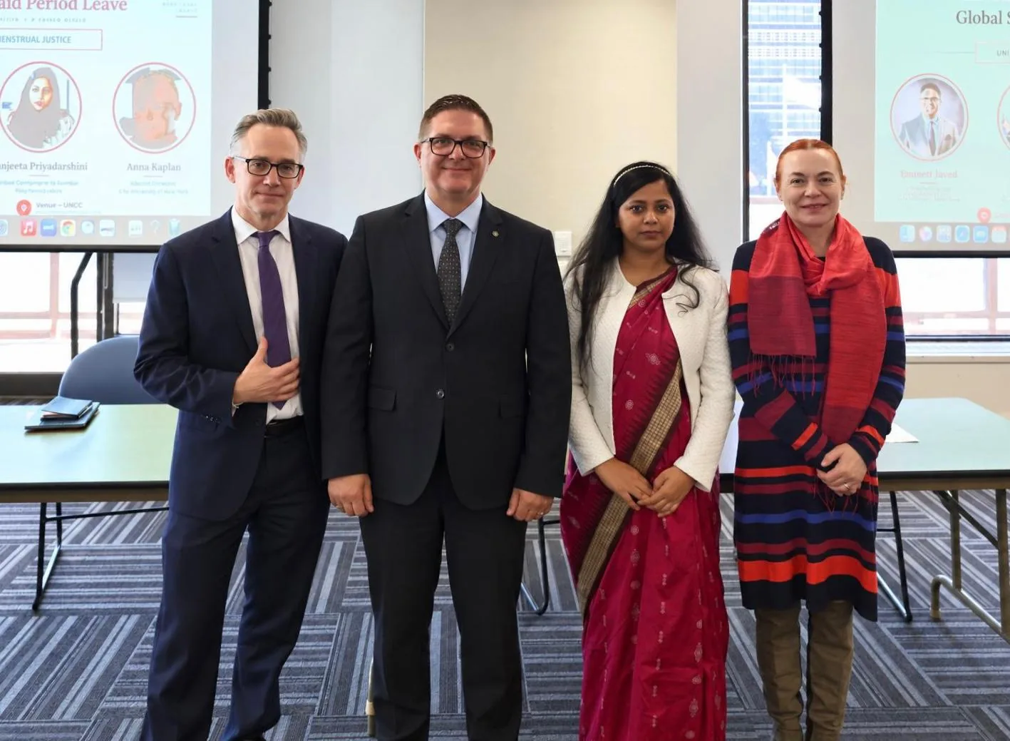 The four panel speakers stand together after the session